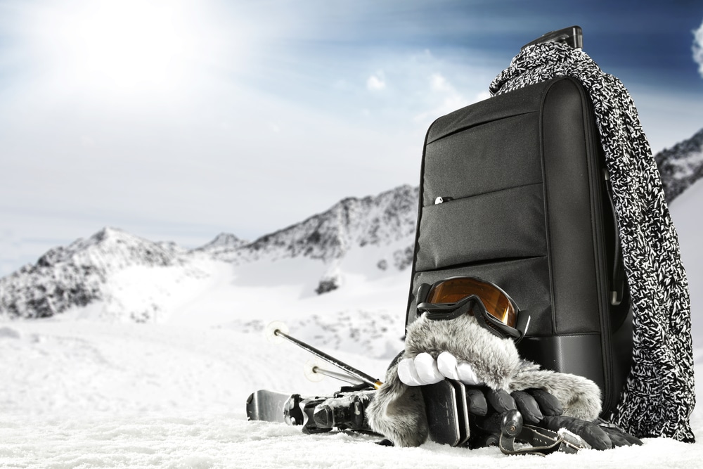 A view of a bag in snow with all the skiing gear