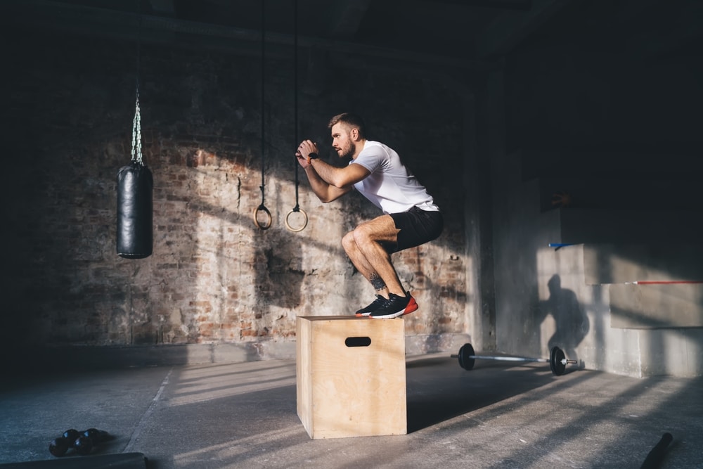 A view of a man doing box jumps