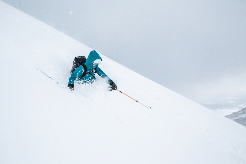 A view of a person skiing in intense snow