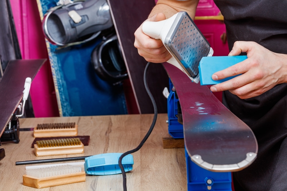 Worker In Workshop Melting Wax To Spread Thoroughly Onto Mountain