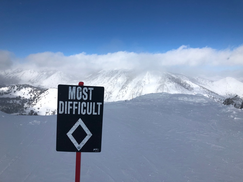 A view of a signboard of the black diamond skiing in snow