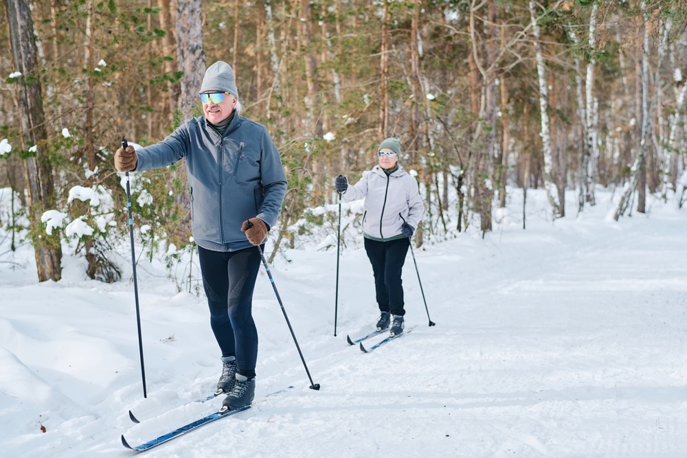 A view of two old people skiing