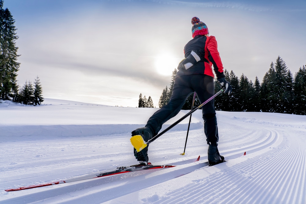 Beatiful Active Senior Woman Cross country Skiing In Fresh Fallen Powder