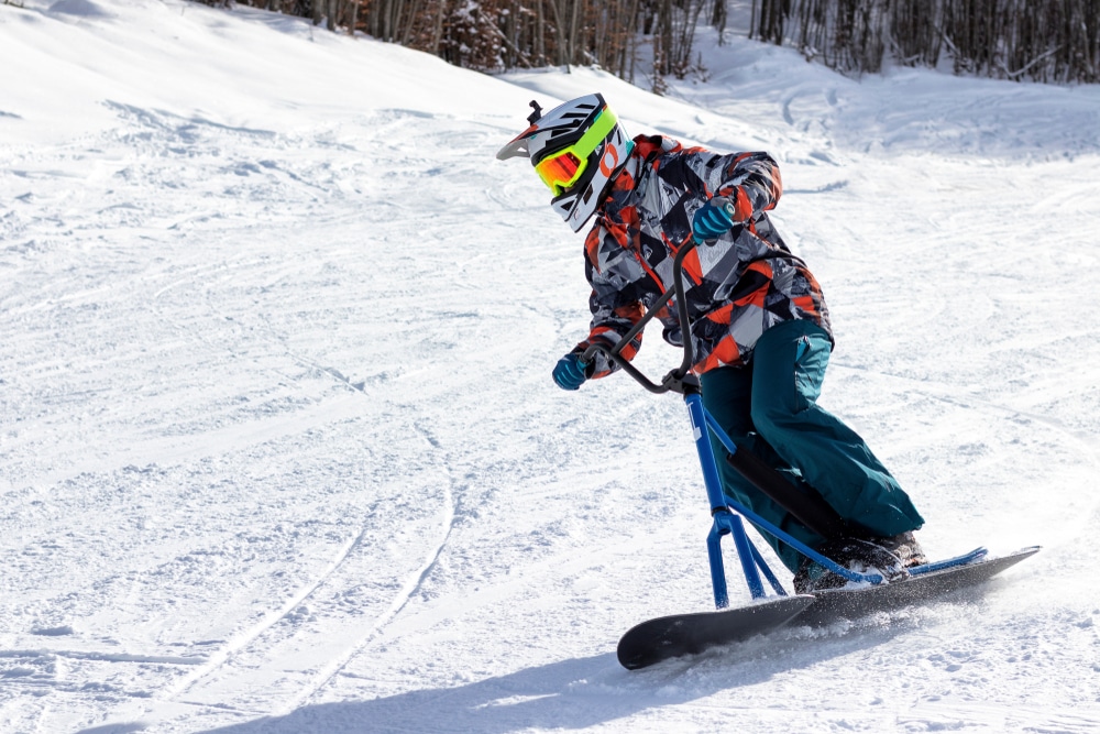 Riding Downhill On A Snow Bike (skiing)