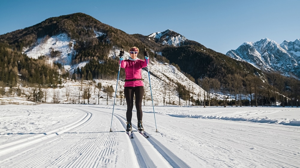 Smiling Middle Aged Female Recreational Cross Country Skier Enjoying Nature