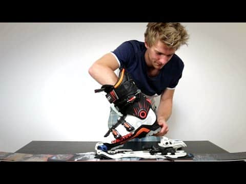 a man adjusting ski binding