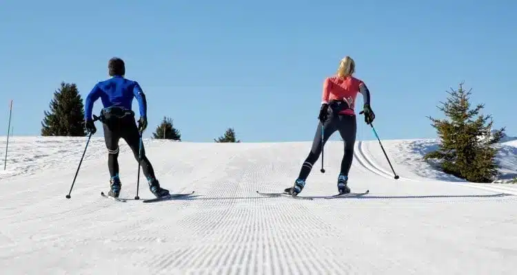 a man and a woman doing skate skiing