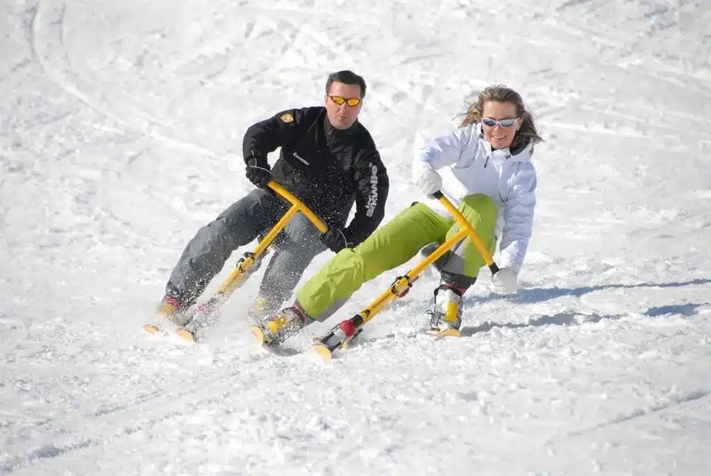 a man and a woman riding their ski bikes