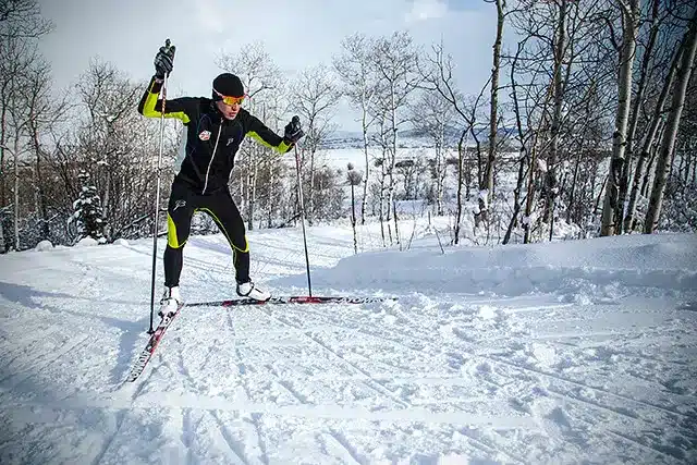 a man doing skating by holding the skate poles in hand