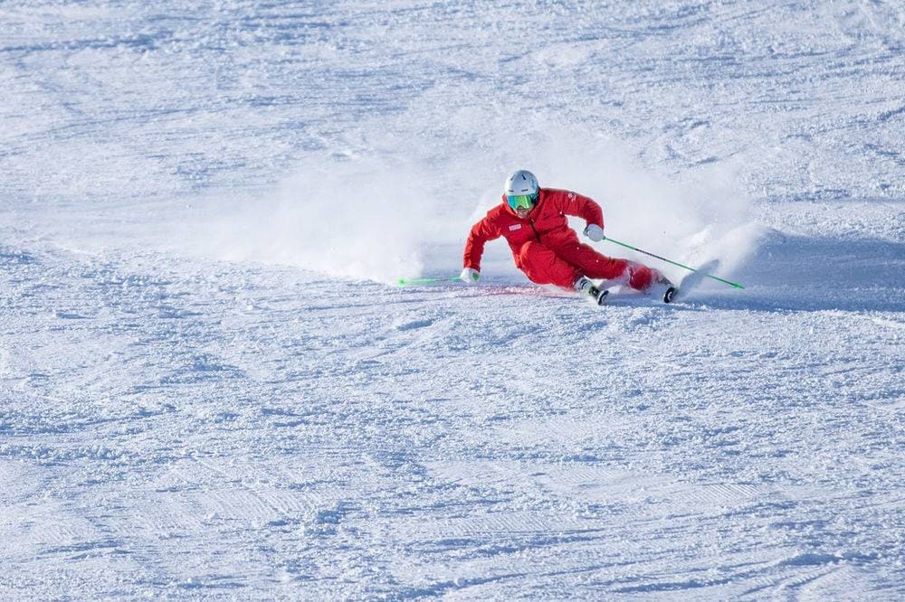 a person taking a turn during ice skiing