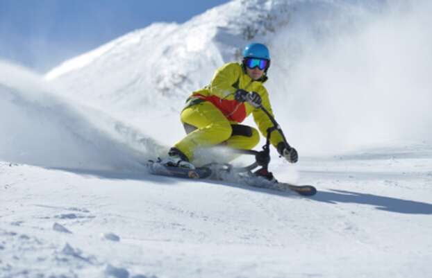 a rider riding a ski bike in snow