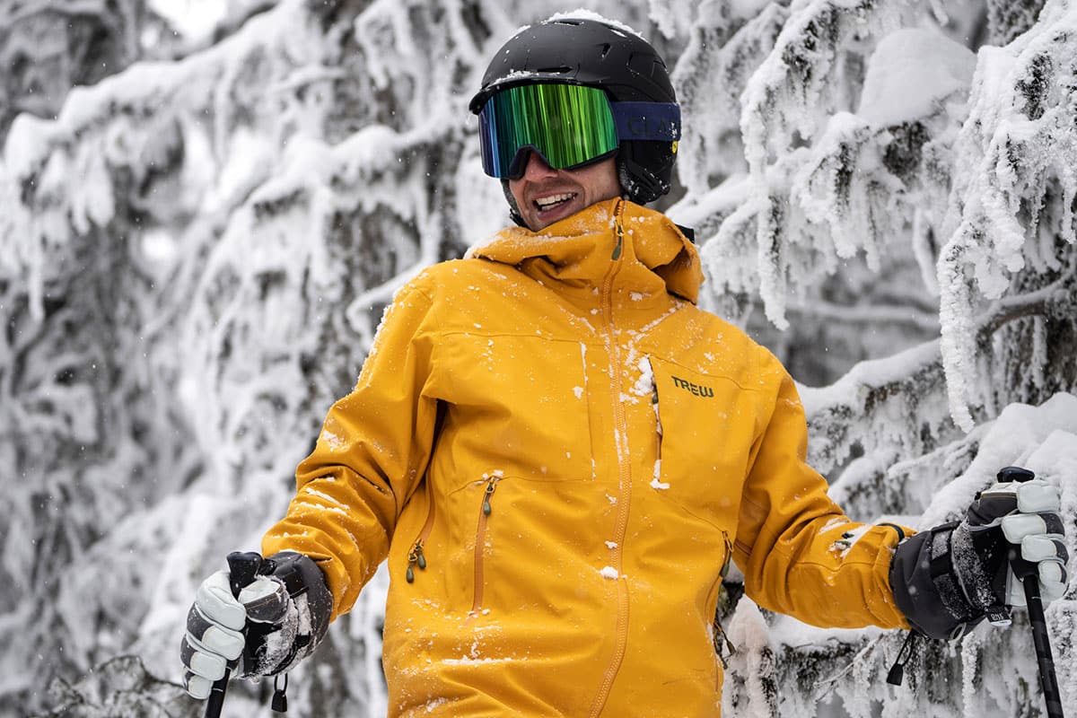 a skier wearing a yellow ski jacket