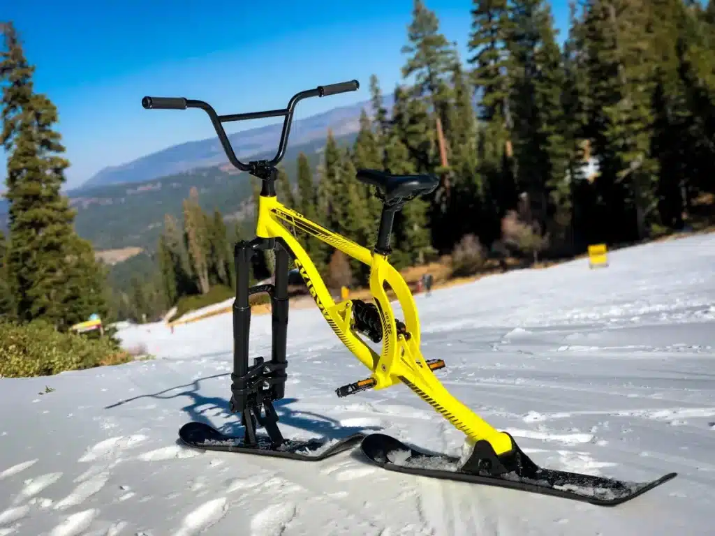 a yellow ski bike parked in a snow