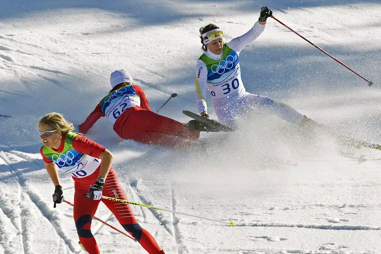 atheletes fallen down during skate skis