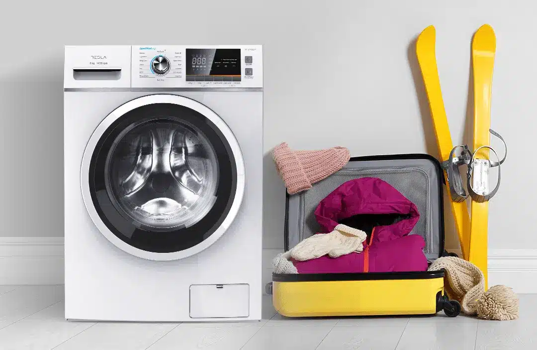 front load washing machine with a bag containing skiing gear