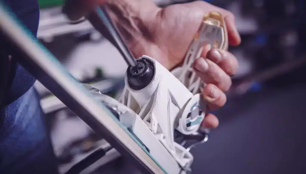 man showing how to adjust ski bindings