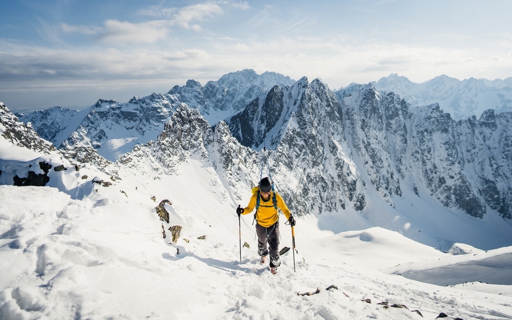 Active Man Ski Touring At Mountains Background At Sunny Winter