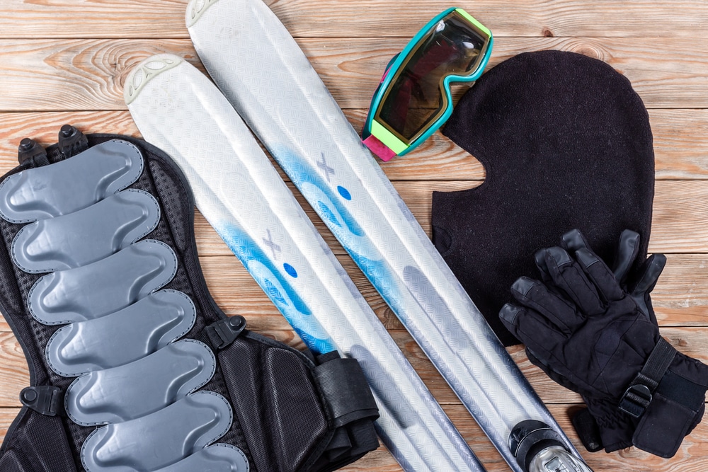 Overhead View Of Ski And Snowboard Accessories Placed On Rustic