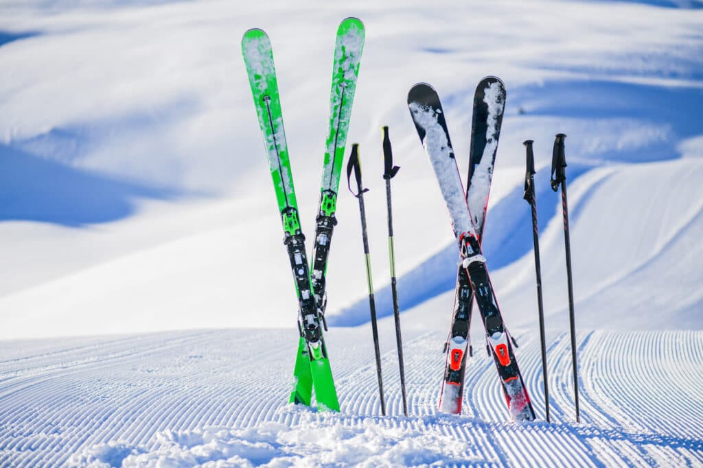 skis of different lengths immersed in a snow in standing position