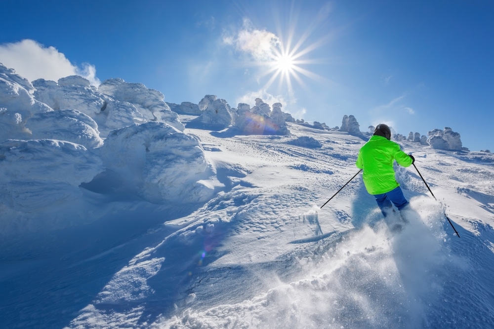 Skier Skiing Downhill In High Mountains Against The Fairytale Winter