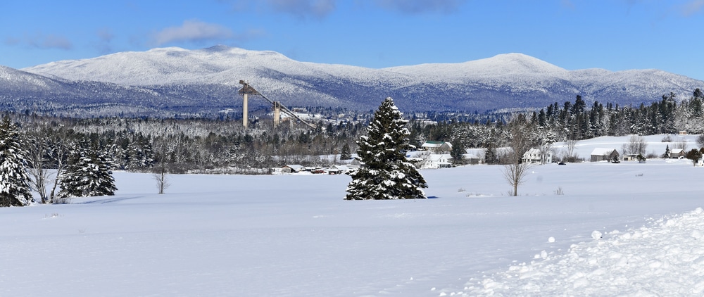 Snow Covered Landscape With Ski Jumps In Background Lake Placid