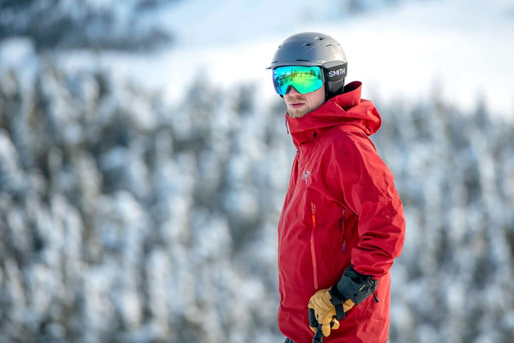 a skier wearing Smith IO Mag ski goggles