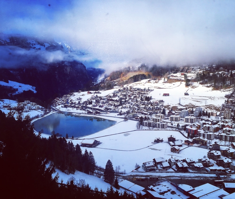 High Landscape Of Engelberg Covered With Snow And Beautiful Mirror