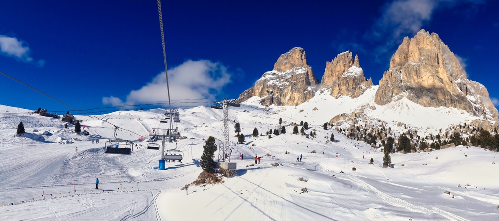 Winter Panorama Of Ski Slope And Snowy Rock In Selva