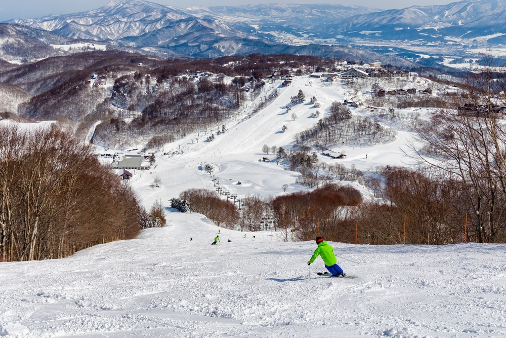 Downhill Skiers In The Japanese Ski Resort Of Madarao In