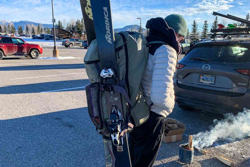 A back view of a girl wearing a skiing boot bag A back view of a girl wearing a skiing boot bag