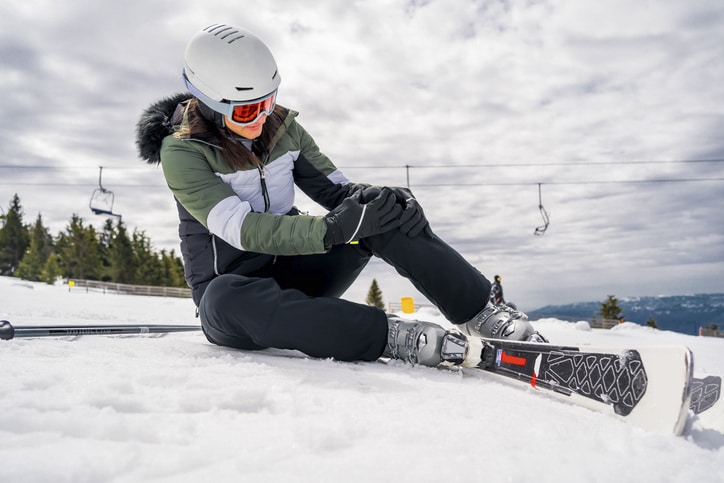 A view of a woman sitting in snow after a ski fall A view of a woman sitting in snow after a ski fall